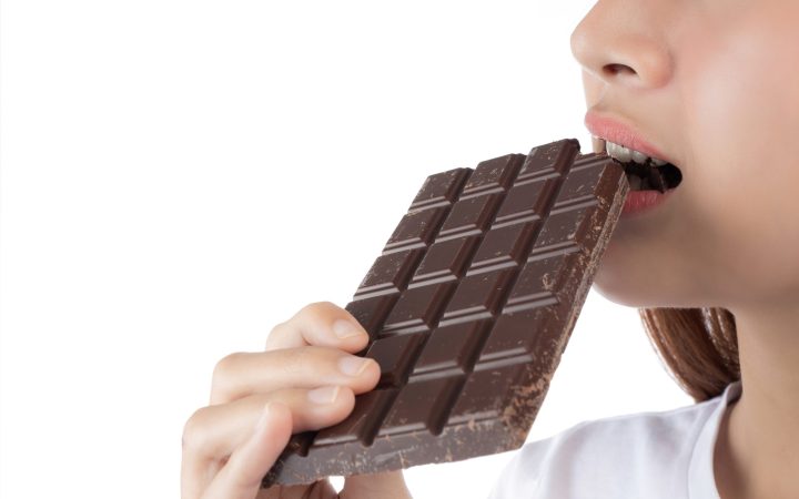 beautiful-woman-with-happy-smile-holding-hand-chocolate