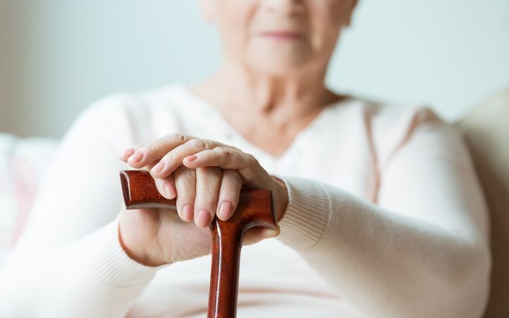 elder-holding-walking-cane-PG8YKBR