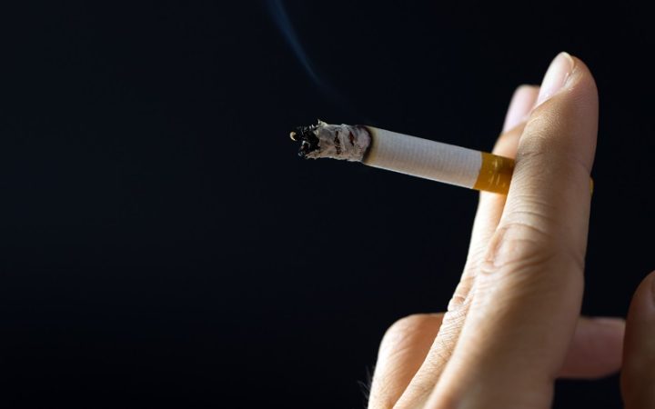 hand-holding-cigarette-smoking-P2ZLXSD