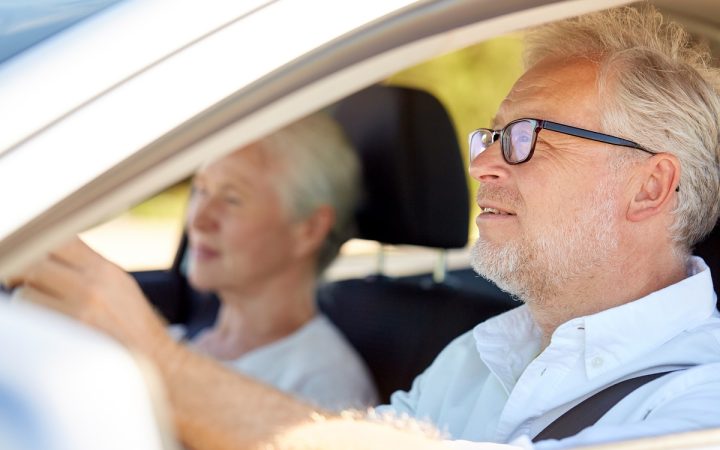 happy-senior-couple-driving-in-car-PU98WBC