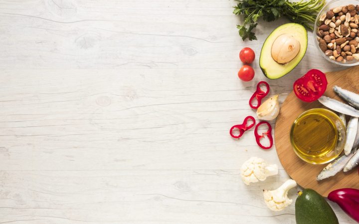 healthy-vegetables-dryfruits-oil-raw-fish-wooden-table