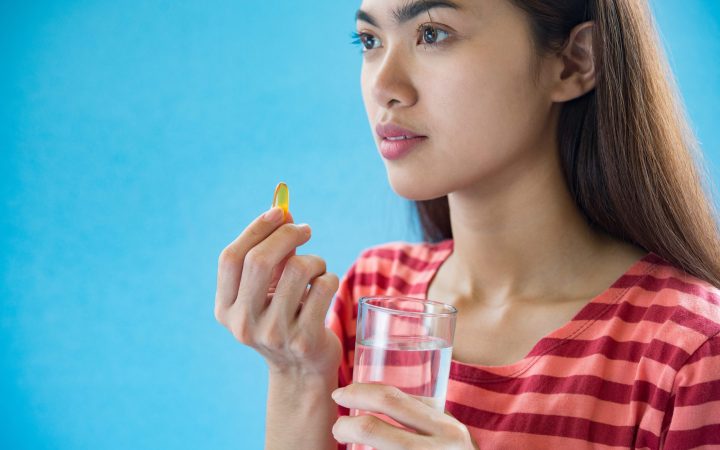 young-woman-taking-medicine-pill-after-doctor-order